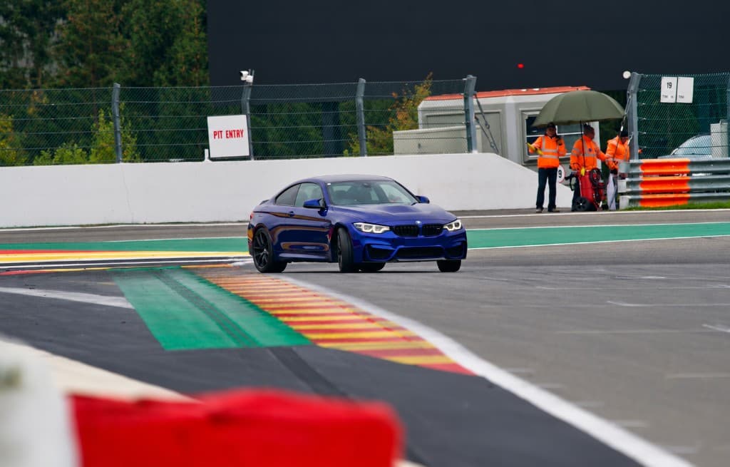 A blue coupe on a racetrack during a track day