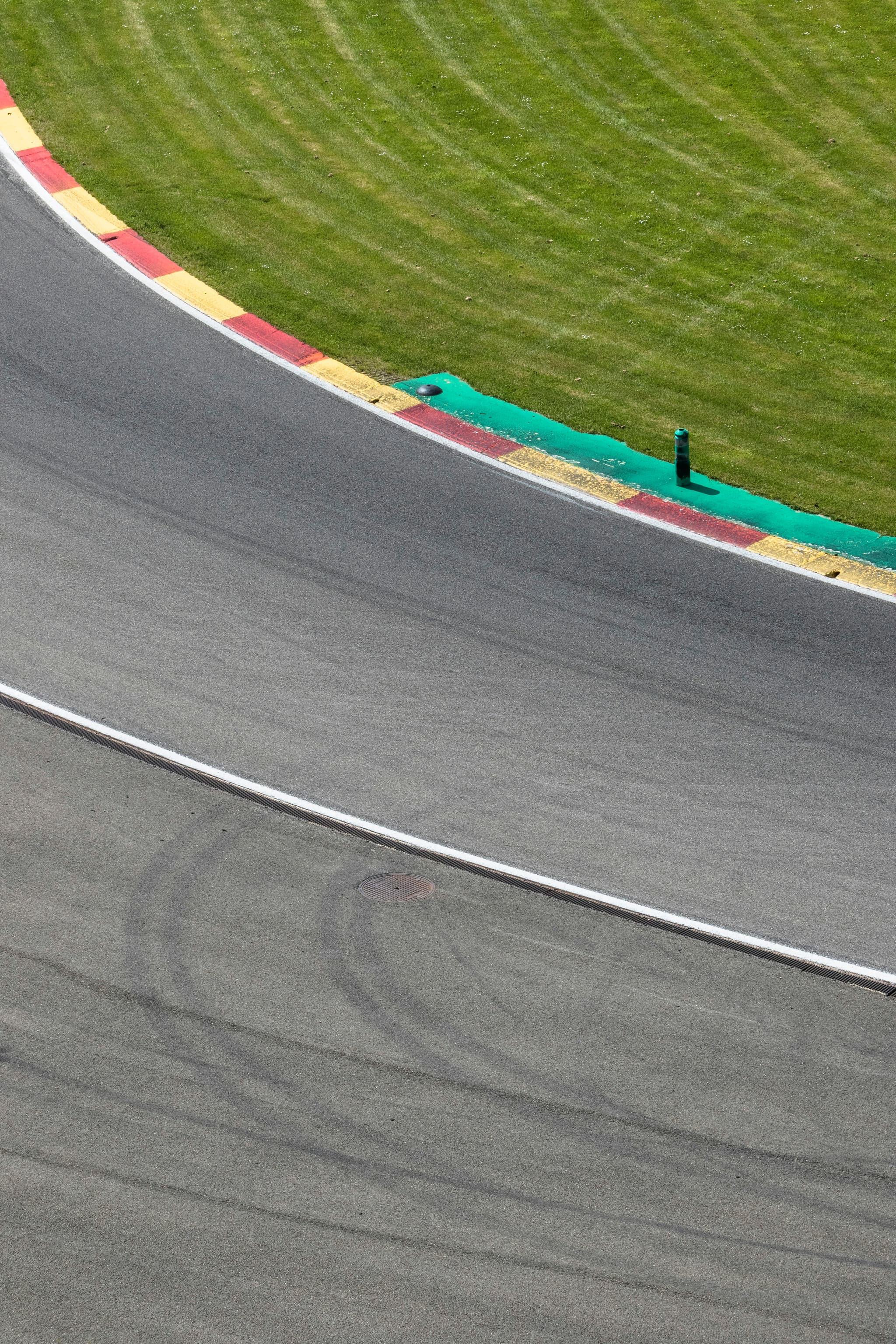 A racetrack curve with red and yellow kerbs